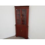 Large reproduction mahogany corner unit, in Regency style with glazed doors and keys for both locks,