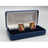 Pair of silver and enamel cuff links depicting nude woman