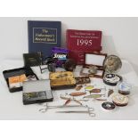 A lot of fishing lures, spoons ,flies together with fishing reels ,record book and a directory of