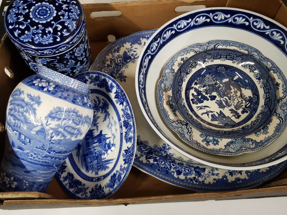 Box containing blue and white bowls and plates, different makers include Doulton, Spode etc