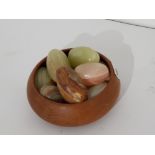 Wooden carved bowl with 10 carved stone eggs