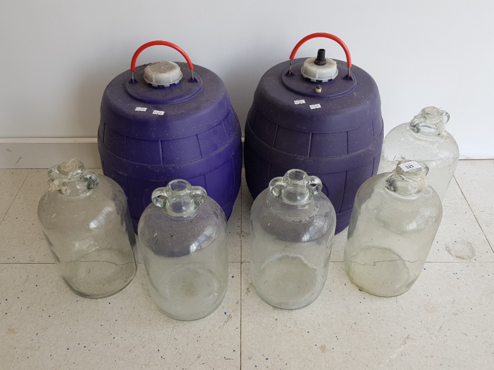 2 plastic caravan water barrels and 5 large glass demijohns