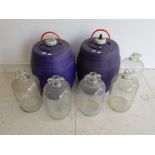 2 plastic caravan water barrels and 5 large glass demijohns