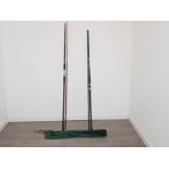 Two sea fishing rods with rod covers, one vintage beach caster with one missing eye and a