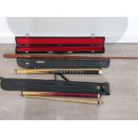 Three pool cues with cases