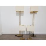 Set of four brass lamps with cream lampshades.to include two standard lamps and two bedside lamps by