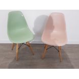Two modern contemporary chairs.one green and one pink