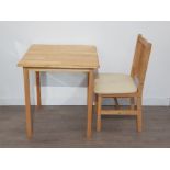 Small solid pine table with one chair.