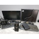2 Dell pc monitors and computer towers with keyboards and pair of speakers