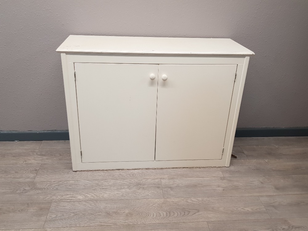 White painted storage cabinet shelved internally with three shelves.two doors to front