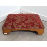Vintage pine based low footstool with upholstered metal studded floral patterned cushion top, on