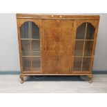 A 1930s walnut veneers display cabinet with glass shelves.122cm×29cm and 115 cm high