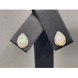 A pair of silver and opal pear shaped earrings