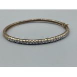 Ladies 9ct gold stone set bangle. 10.09g