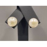 A pair of silver and large cultured pearl studs earrings