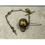 A novelty brass watch chain with skull vesta