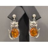 A pair of silver and amber style cat earrings