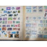 Album containing mixed stamps from around the world including british stamps also features indian,