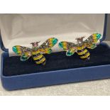 A pair of silver enamelled Bee style cuff links