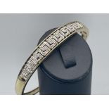 Ladies gold Versace style diamond bangle, set with 43 round brilliant cut diamonds complete with