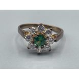 Ladies 9ct gold green stone cluster ring. Comprising of green centre stone surrounded by 8 CZ all