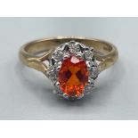 Ladies 9ct gold fire opal and diamond cluster ring, comprising of oval centre stone surrounded by