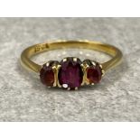 15ct gold 3 stone ring. Comprising of 3 red stones 2.5G size M1/2