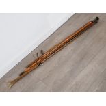 Vintage fishing sticks and fishing stand together with 2 walking sticks