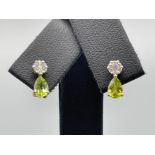 Ladies 9ct gold peridot and diamond stud earrings. Comprising of pear shaped peridot and cluster