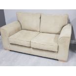 Modern upholstered 2 seater sofa, on beech effect foot supports in good clean condition
