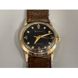 Gents Bulova wristwatch with gold plated bezel and shock resistant, with brown leather strap and