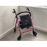 Pink 4 wheeled walking aid with basket