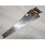 An old Disston and sons Philadelphia D8 hand saw with 26inch blade, the brass medallion is marked