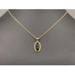Ladies 9ct gold Whitby jet pendant and chain. Featuring oval piece of jet in a gold rub over