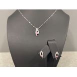 Ladies 9ct white gold and pink stone pendant and matching stud earrings.