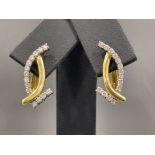 Ladies 18ct gold ornate Diamond earrings. Each set with 14 round brilliant cut diamonds all claw