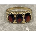 Ladies 9ct gold 3 stone Garnet ring. Comprising of 3 oval shaped stones and heart design