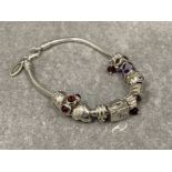 Ladies silver charm bracelet. 11 assorted silver charms complete with lobster catch