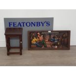 Carved wooden plaque of tavern scene along with a small side table