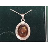 Silver and amber oval shaped pendant on silver chain, 4.7g gross