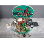 Vintage tin containing miscellaneous costume jewellery includes brooches, dress rings, cuff links