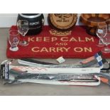 A keep calm and carry on door mat along with a 100 pipers scotch whiskey ice bucket carlsberg wall