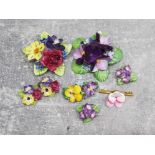 4 china flower brooches and 2 pairs of china flower clip on earrings