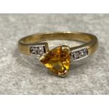 Ladies 9ct gold Citrine and Diamond ring. Comprising of a centre Citrine stone with 2 round