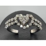 Ladies 18ct white gold diamond heart ring. Featuring 3 round brilliant cut diamonds in centre