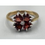 Ladies 9ct gold Garnet and Diamond ring. Featuring 4 heart shaped garnets and a single round