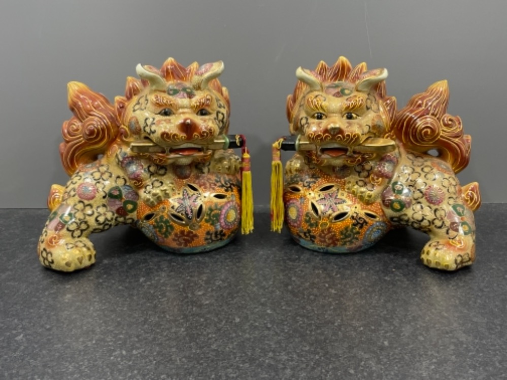 Large pair of Chinese Foo dog ornaments. 26cms x 26cms