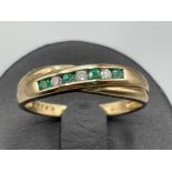Ladies 9ct gold Emerald and diamond ring. Comprising of 4 emeralds and 3 round brilliant cut