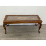 Stunning heavily carved Indonesian style glass top coffee table. 122cm x 42cm x 56cms