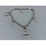 Ladies 9ct white gold Key and lock bracelet. Featuring 3 keys and 2 padlocks set with CZ stones